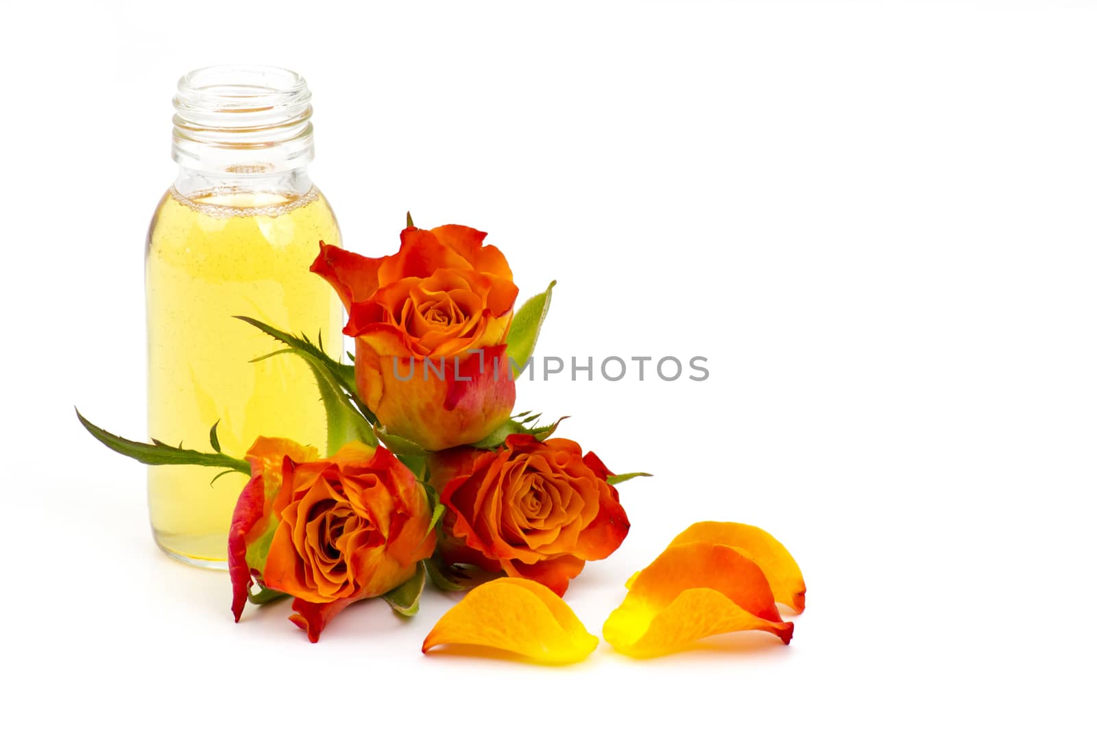 bath oil and orange roses on white background