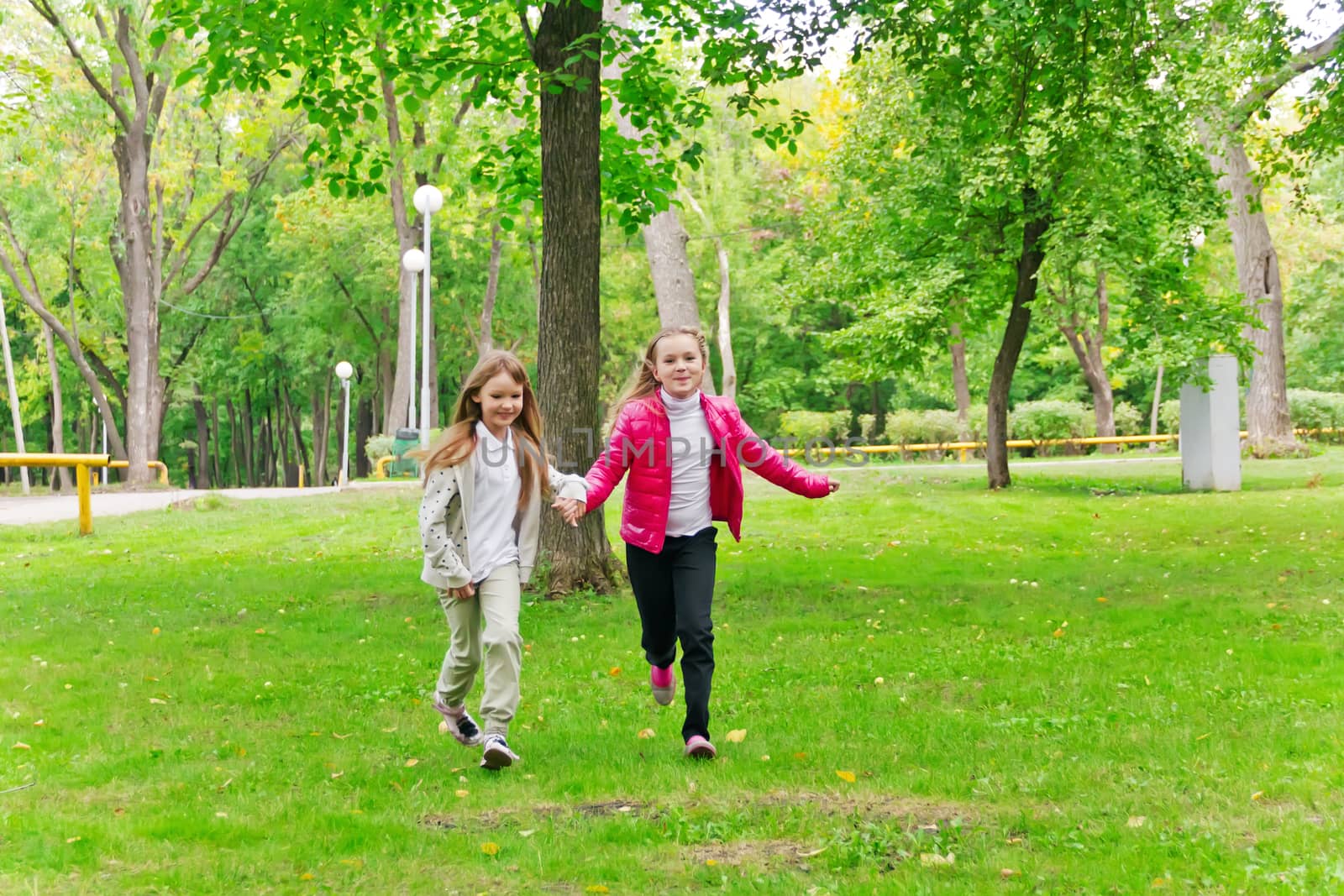 Photo of cute two running girls in summer