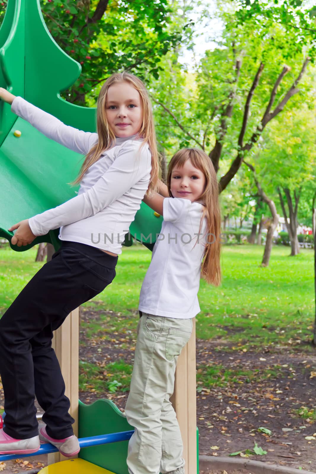 Photo of two playing girls in summer