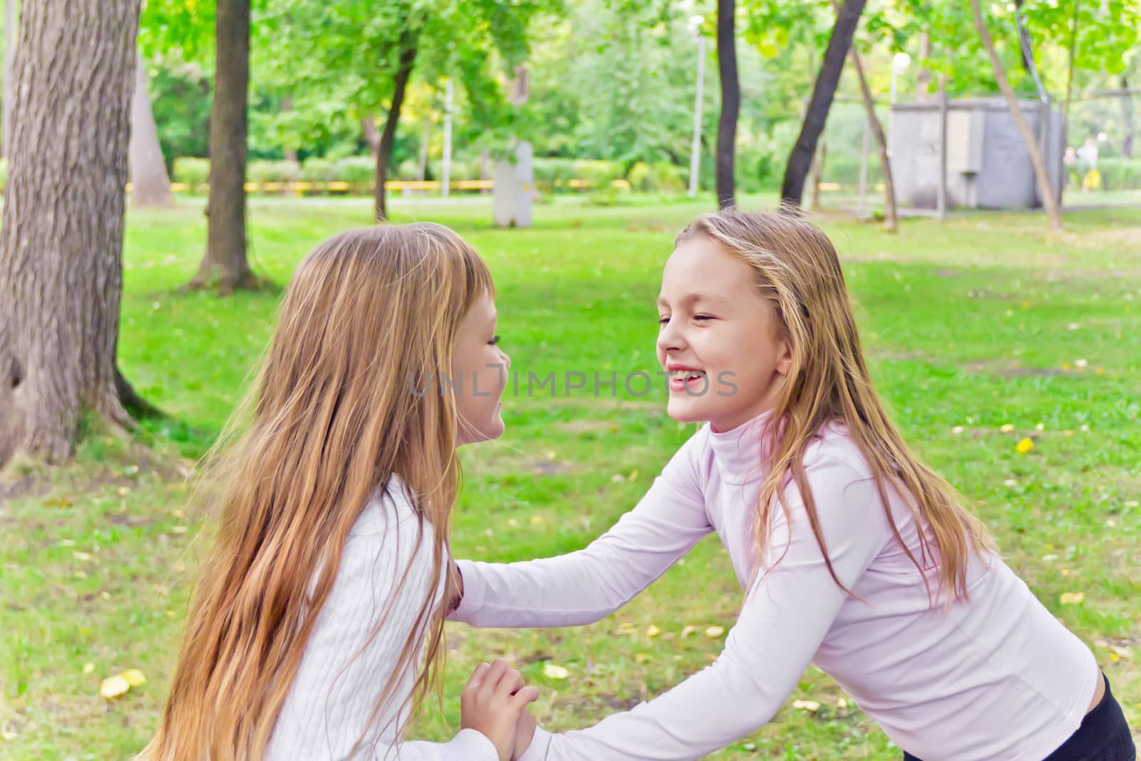 Photo of two playing girls in summer