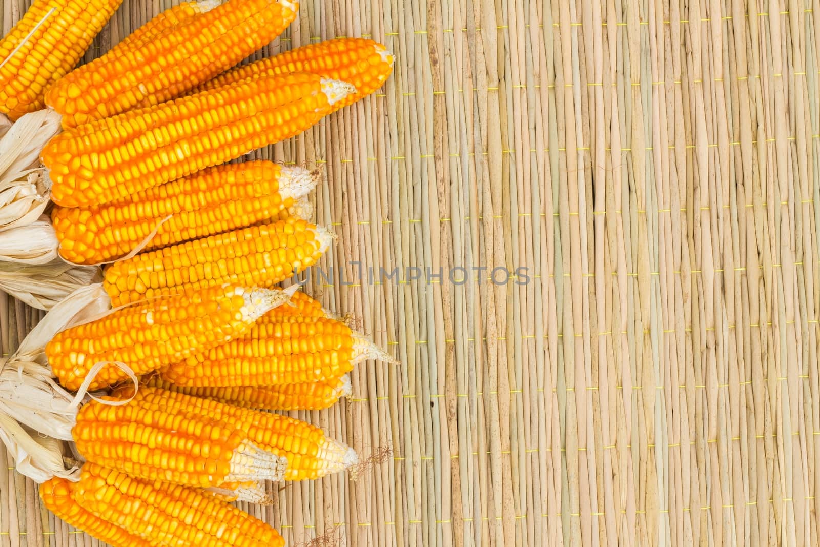 dry corn on thai traditional mat with copyspace on the right, background