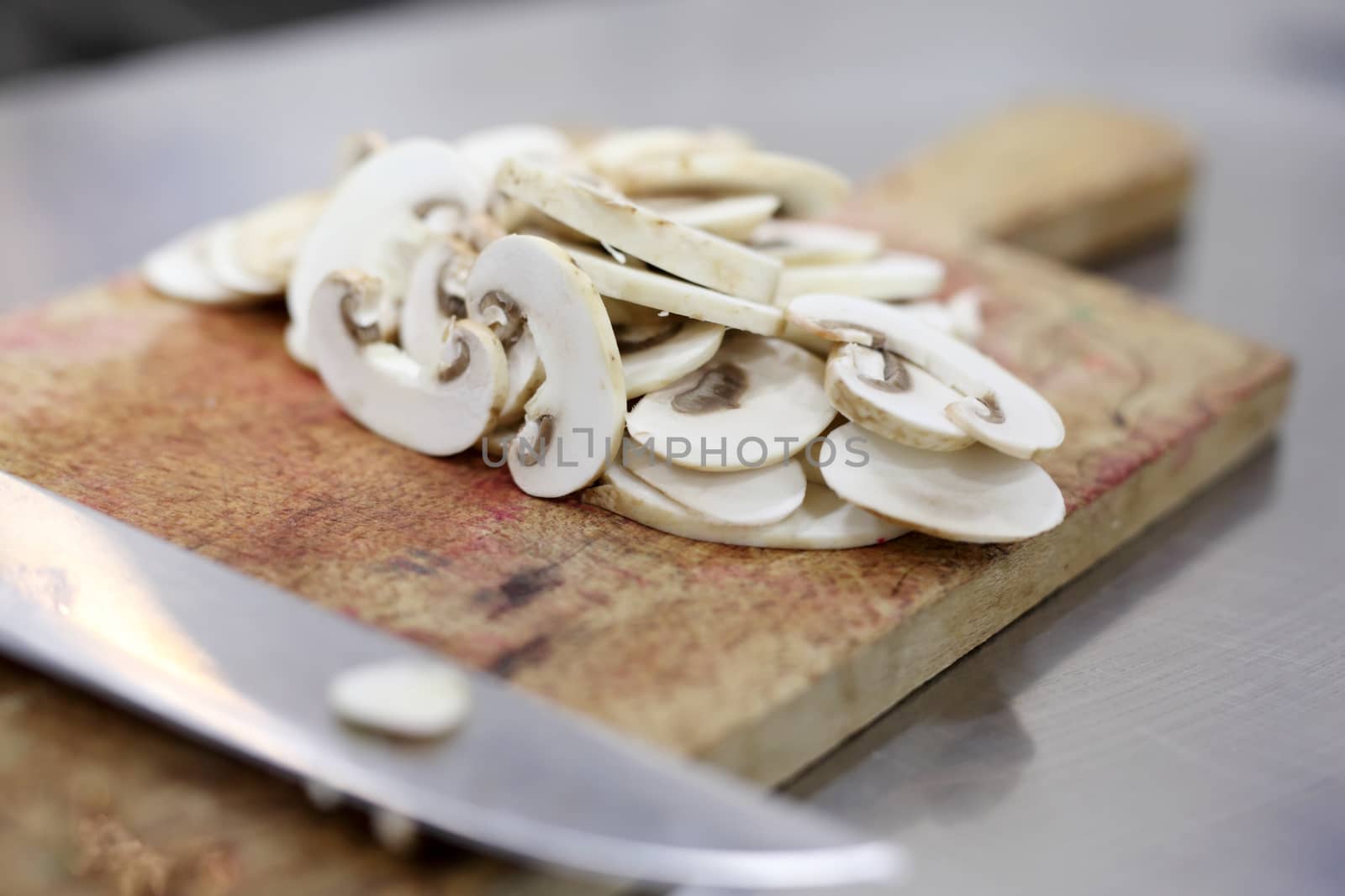 White Champignon mushroom just cutted on a kitchen table