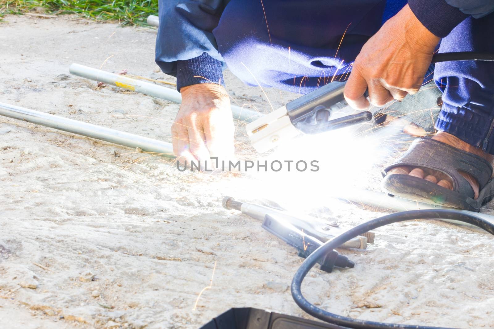 Worker welding the steel part by manual without safety, danger concept