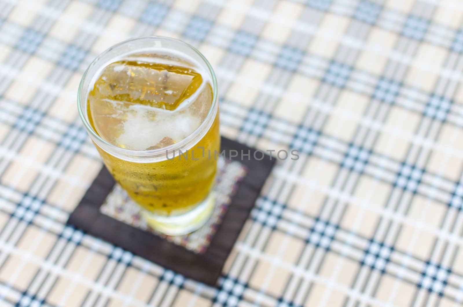 glass of beer on blurred background