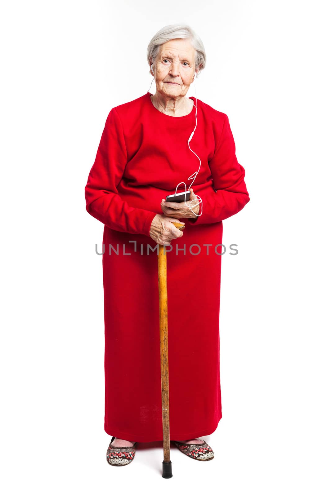 Senior woman listening to music over white background