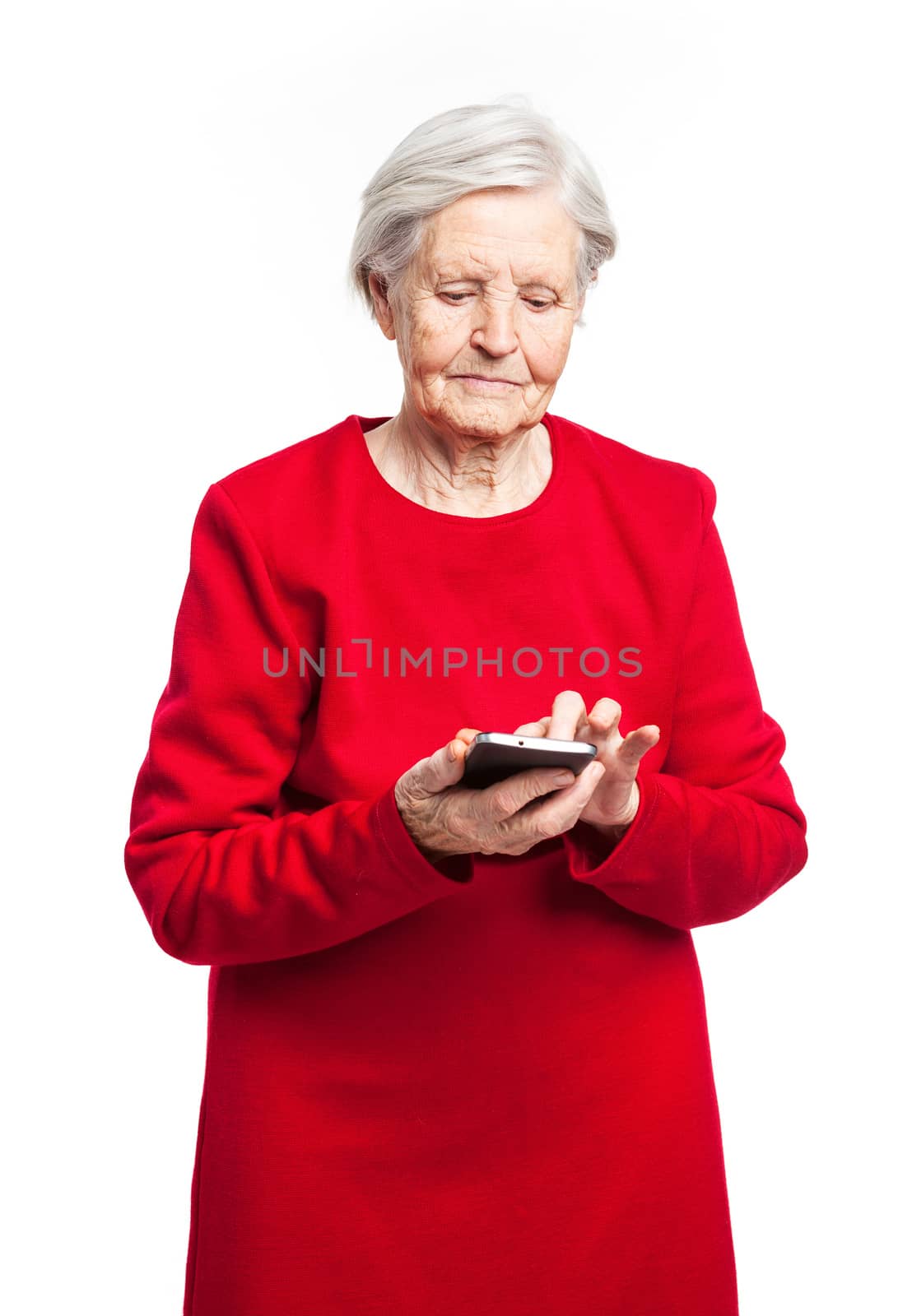 Senior woman using mobile phone over white by photobac