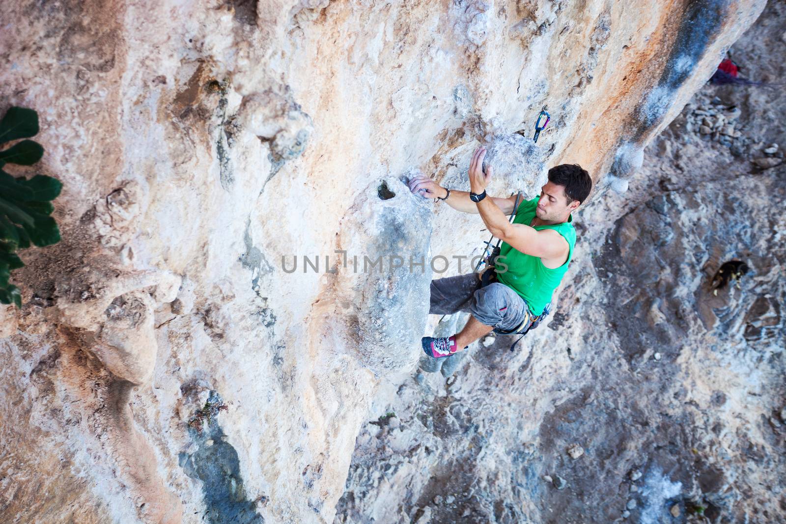 Rock climber on a cliff by photobac