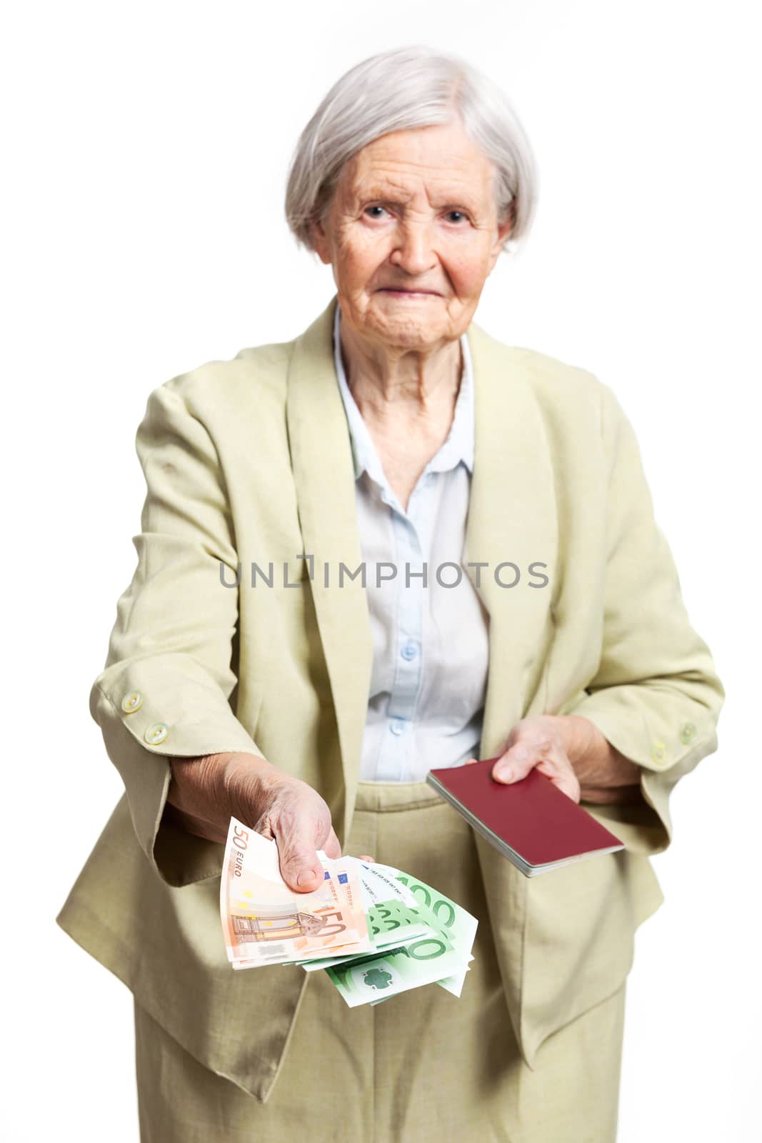 Senior woman giving money and holding passport by photobac