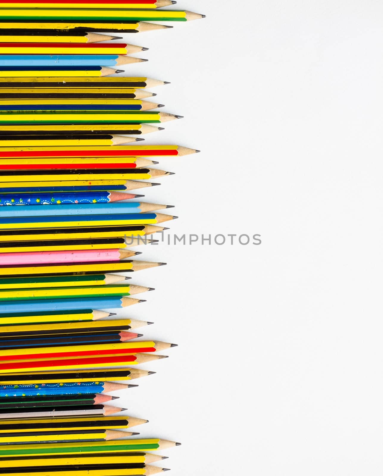 colorful pencils on the white paper, view from above by a3701027