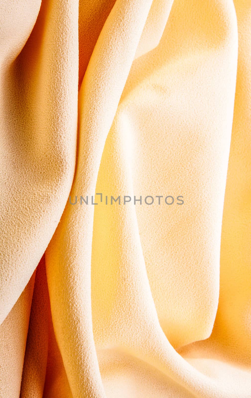 background of bright yellow silk with waves