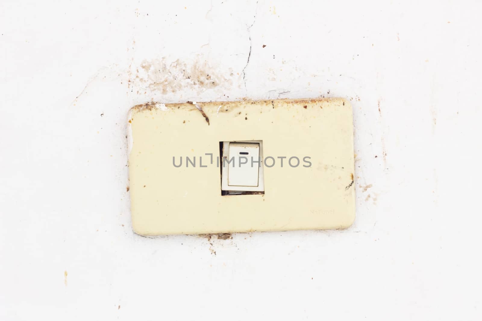 old and dirty electrical switch on dirty wall