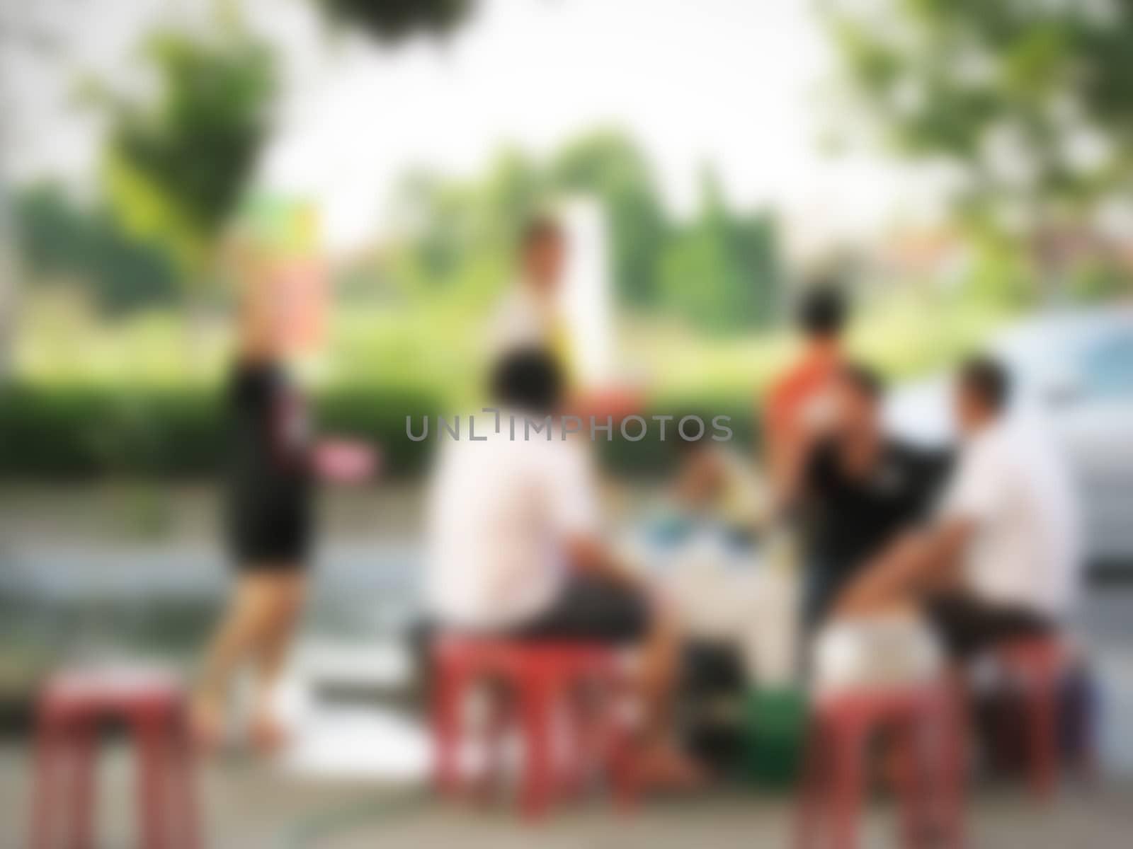 defocused of people sitting on red chair waiting for something