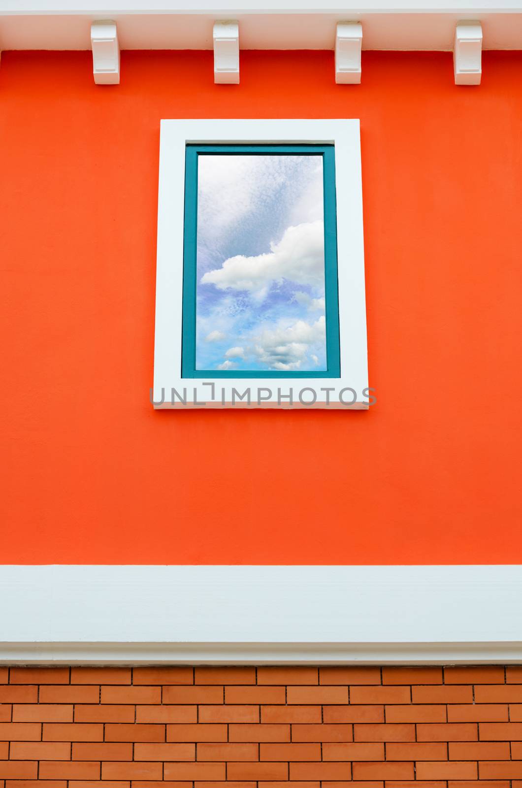 Sky and cloud reflection in window glass on orange wall of house, Italy retro style