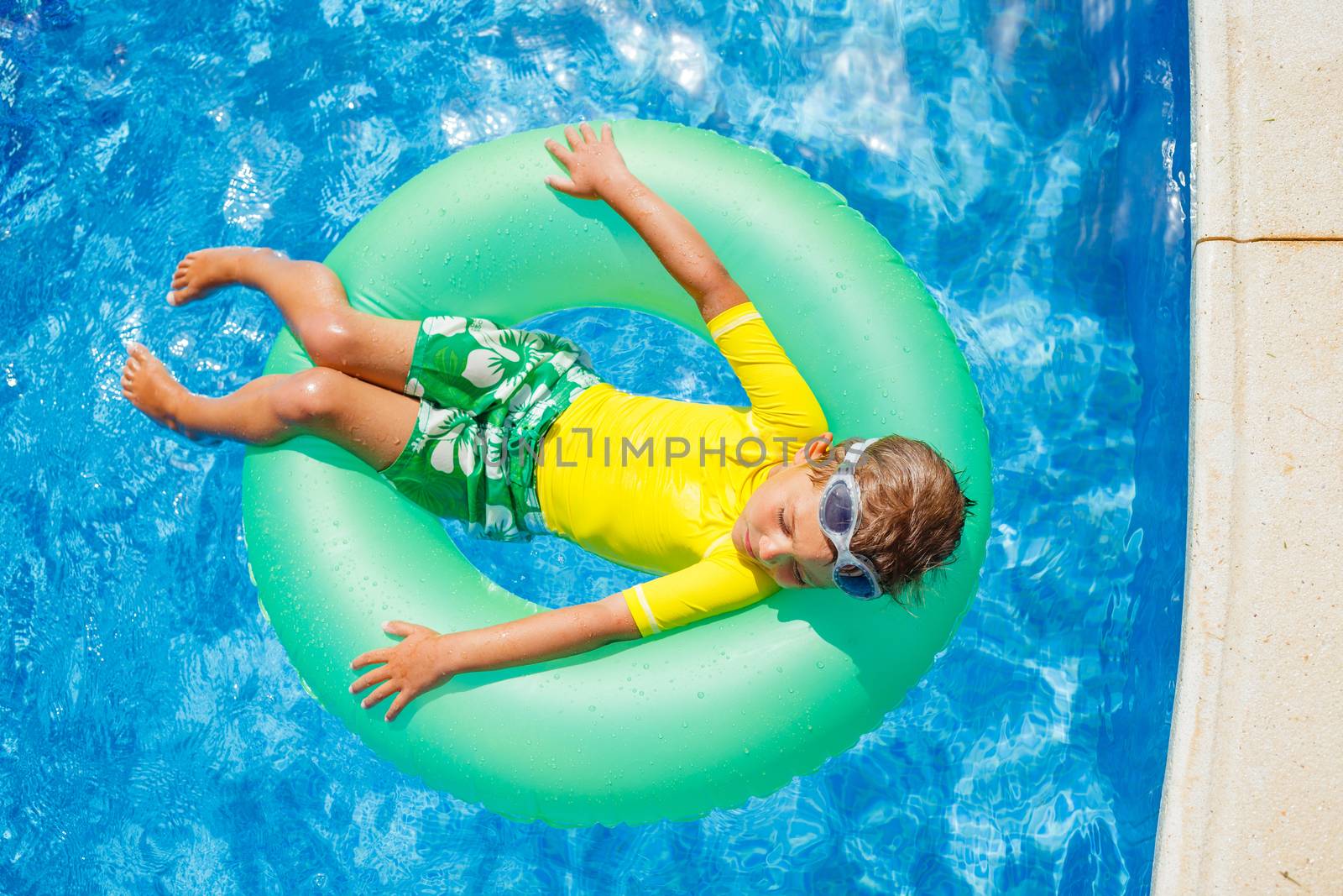 Boy swims in a pool by maxoliki