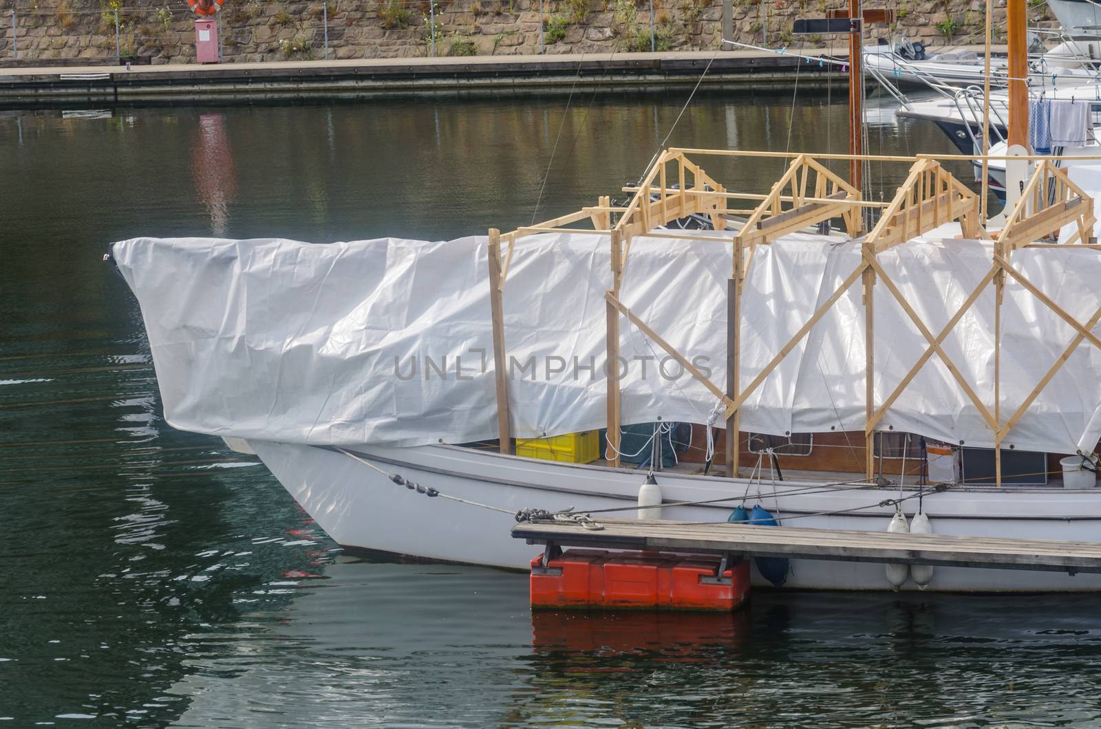Ship renovation, repair under a tent in the harbor.