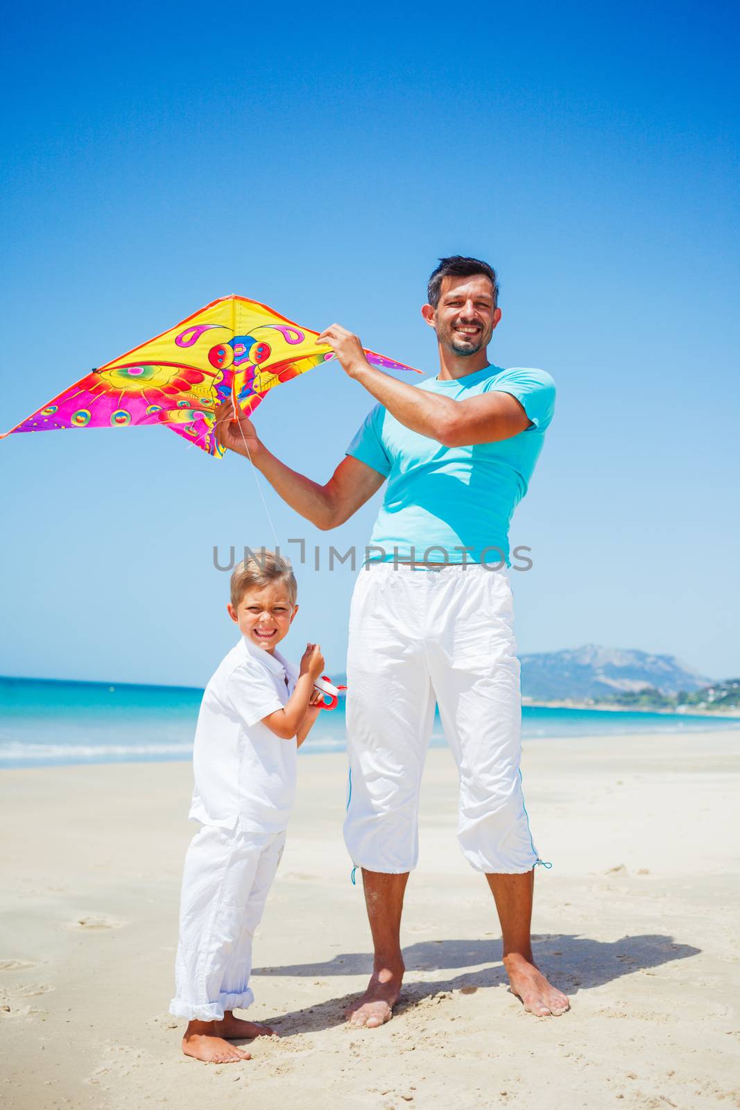 Boy and his father with kite. by maxoliki