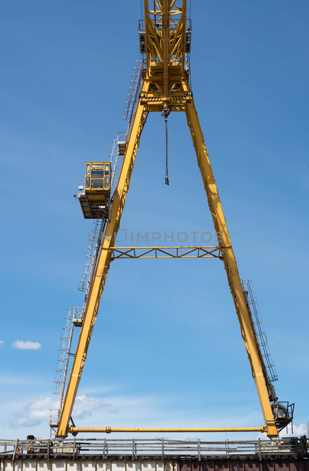 Gantry crane against the blue sky background