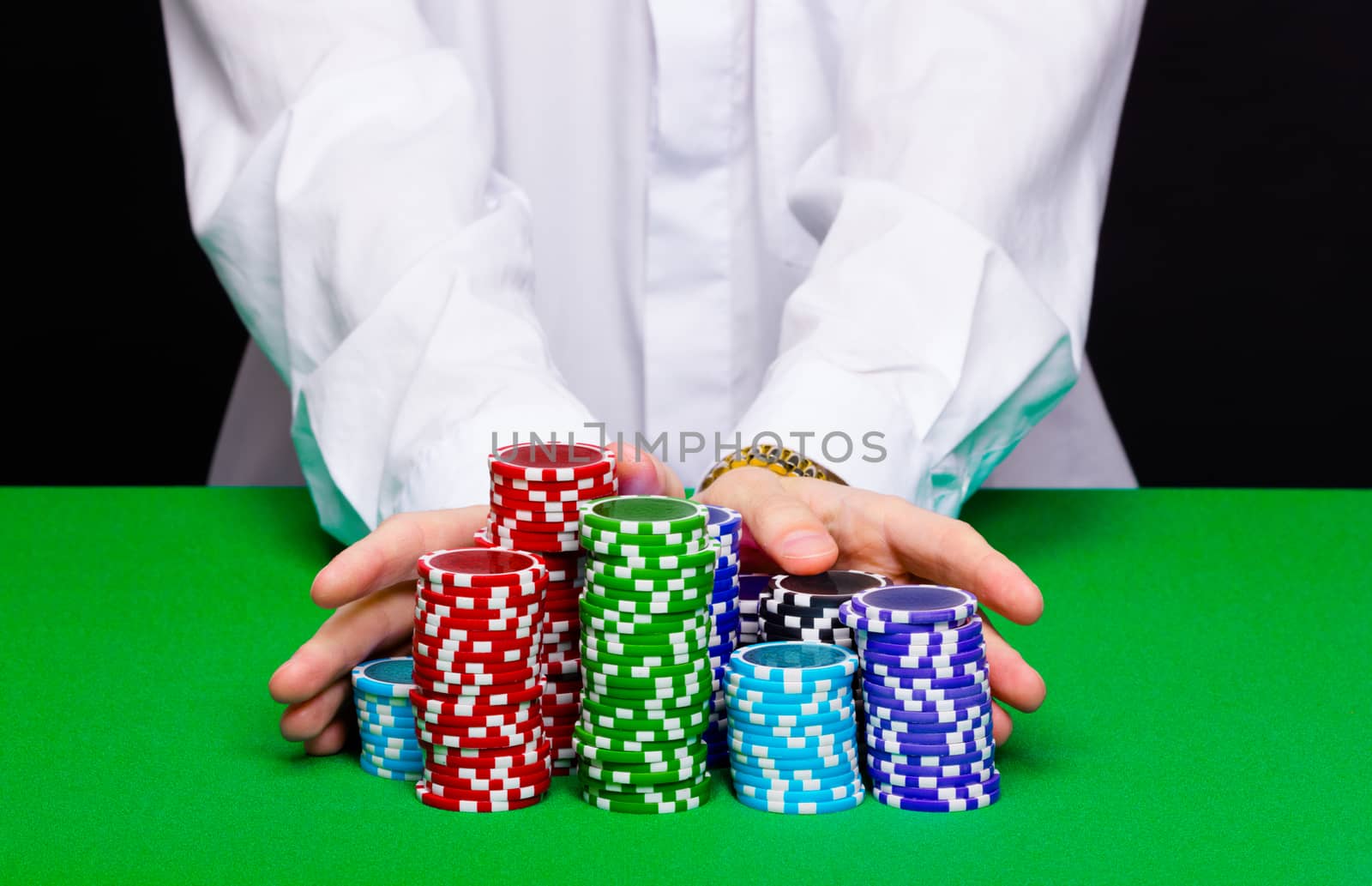 Man puts in the casino. Hand with chips closeup