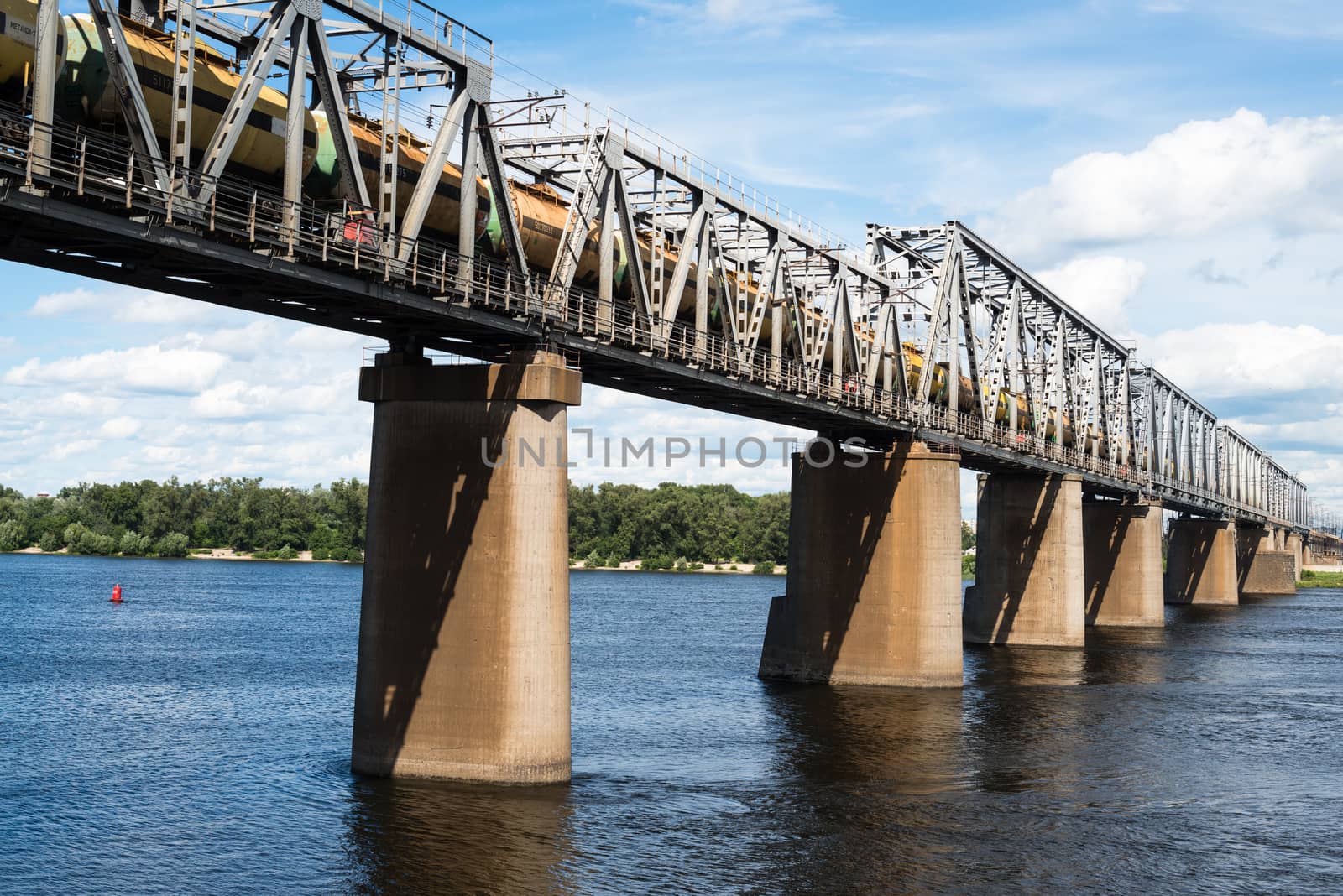 Petrivskiy railroad bridge in Kyiv across the Dnieper with freight train on it.