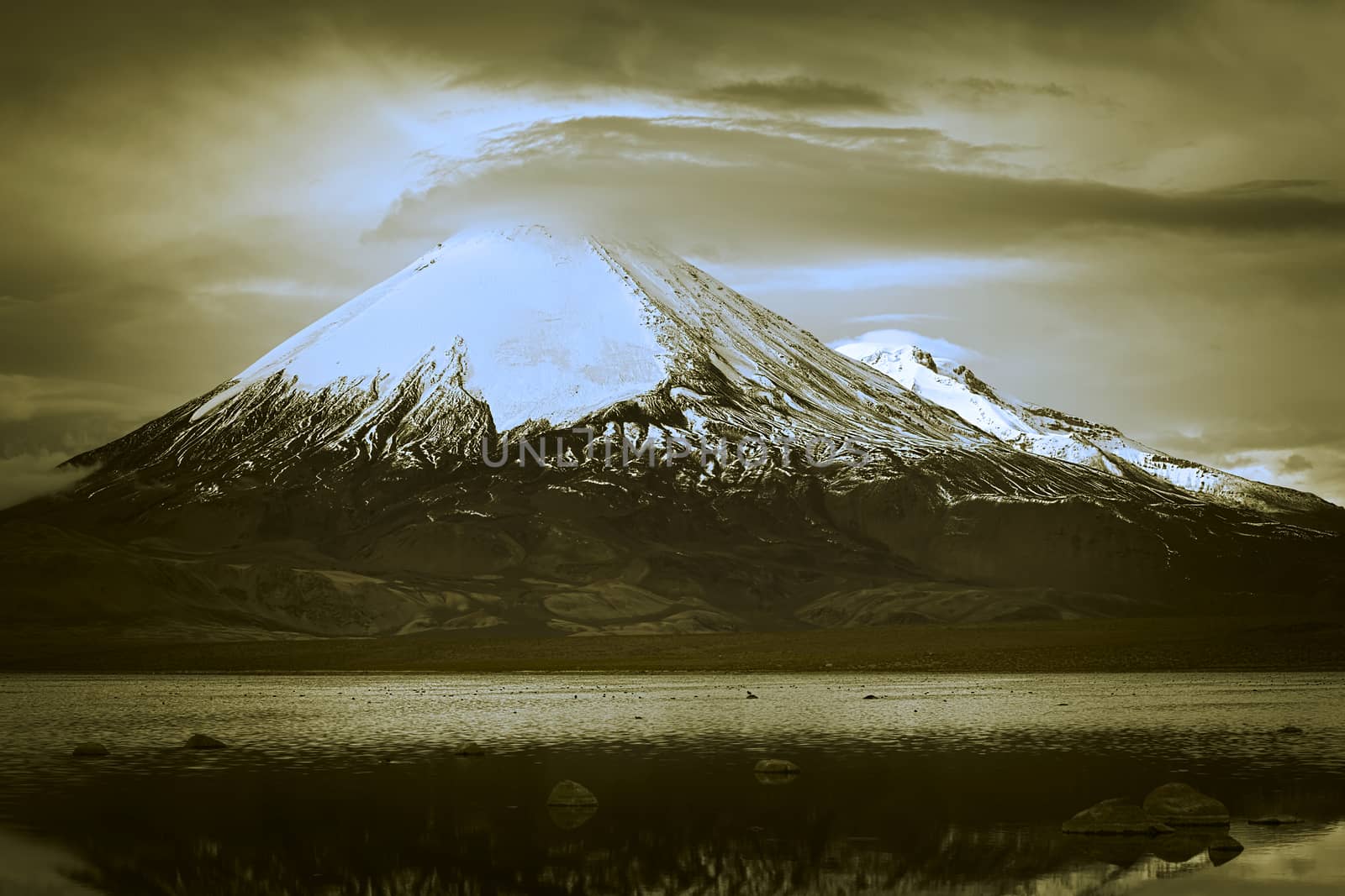 Parinacota stratovolcano (6348 meters) and Chungara Lake on the border of Chile and Bolivia on the way from La Paz to Arica. Parinacota is part of the Payachata volcanic group in Northern Chile. (Dual Toned Image)