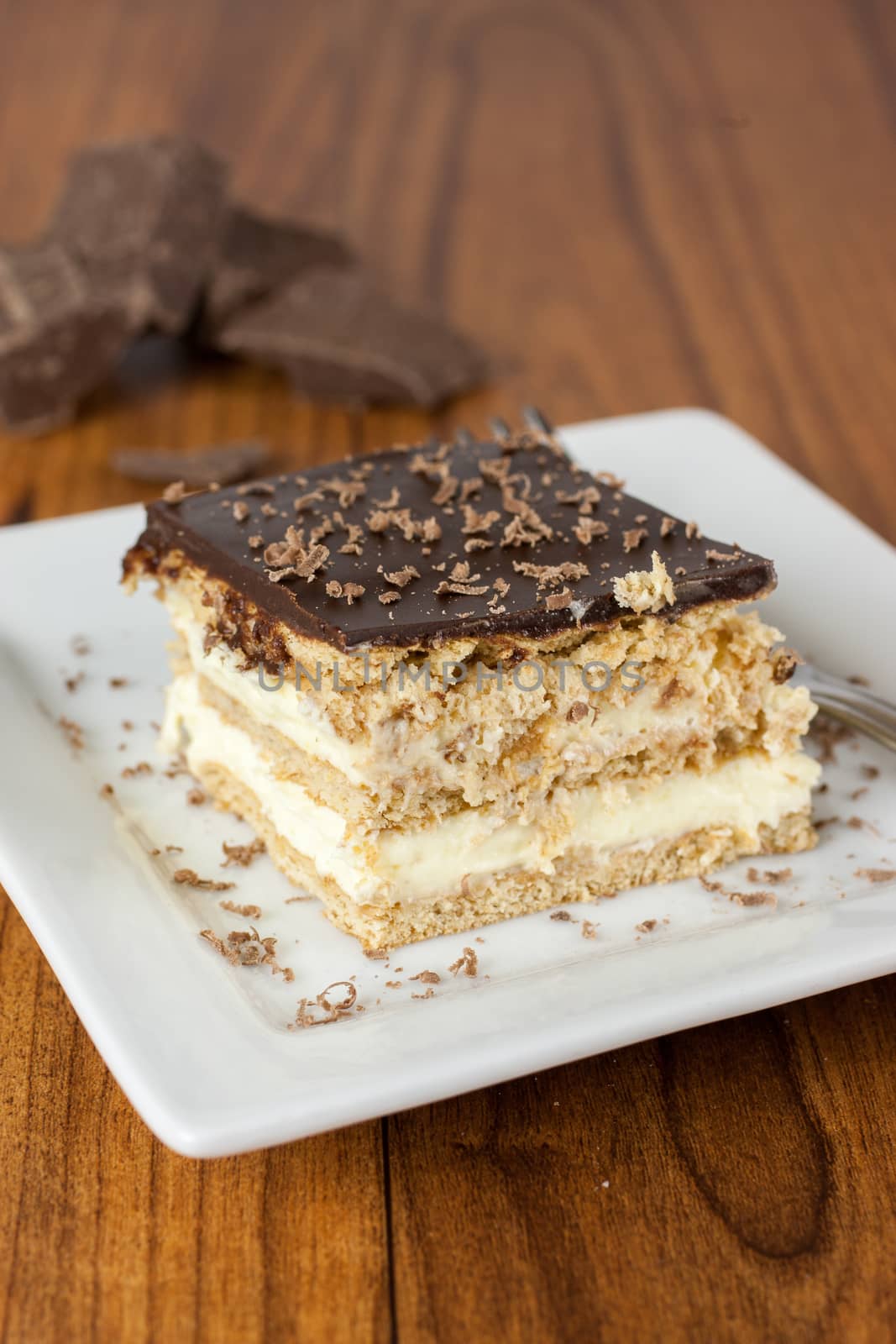 A layered Boston creme pie style dessert made with french vanilla filling and chocolate ganache topping.