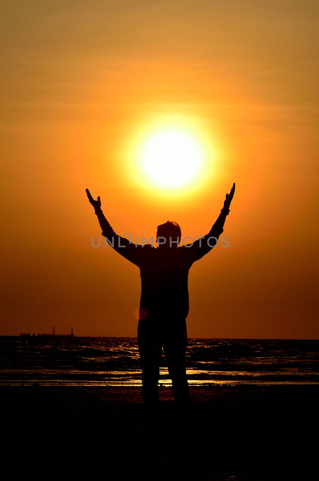 Silhouette man  hold the sun at sea, Love nature concept
