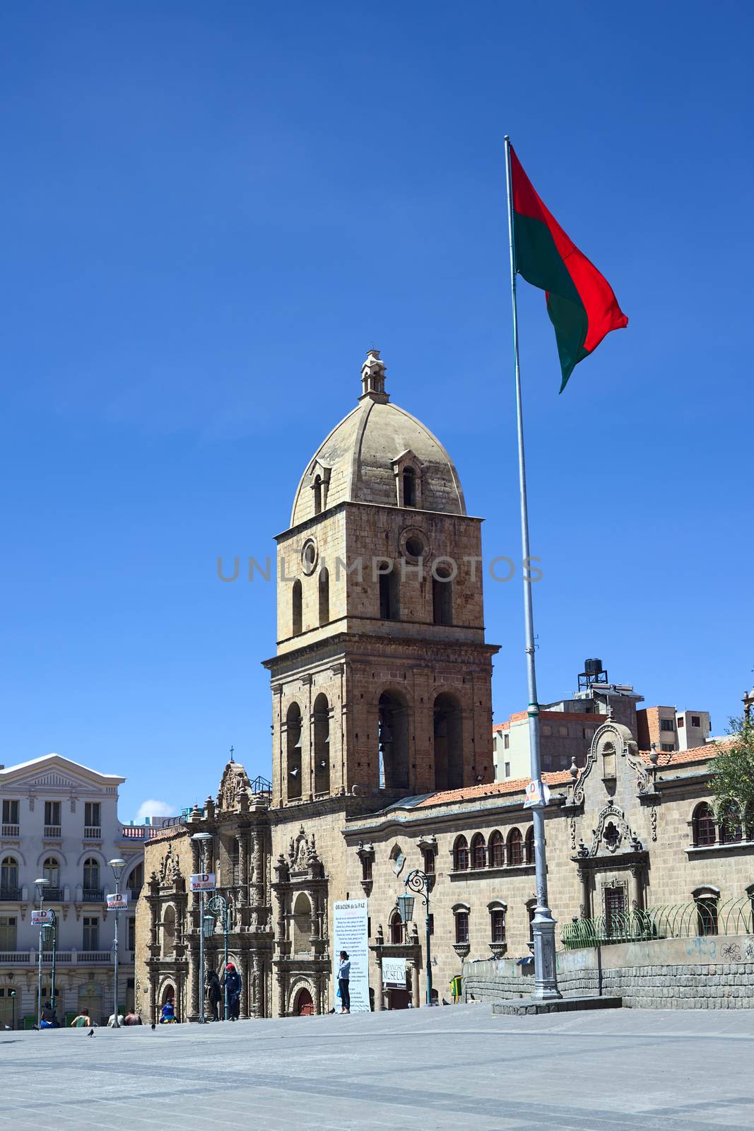 LA PAZ, BOLIVIA - OCTOBER 12, 2014: Basilica of San Francisco and the red-green flag of La Paz on the San Francisco square in the city center on October 12, 2014 in La Paz, Bolivia
