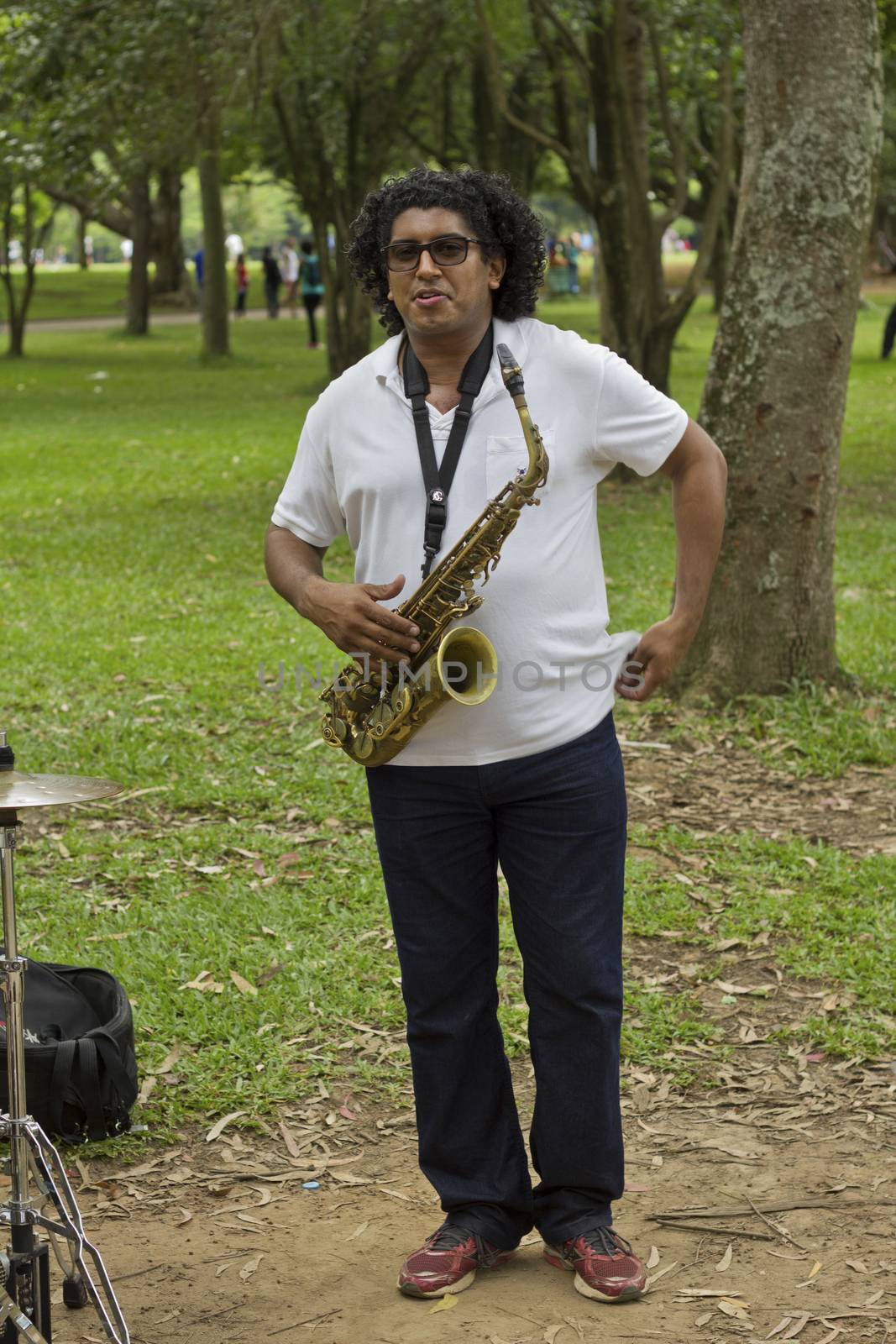 SAO PAULO, BRAZIL - FEBRUARY 01, 2015: An unidentified street musician playing saxophone in the Ibirapuera Park at Sao Paulo Brazil.