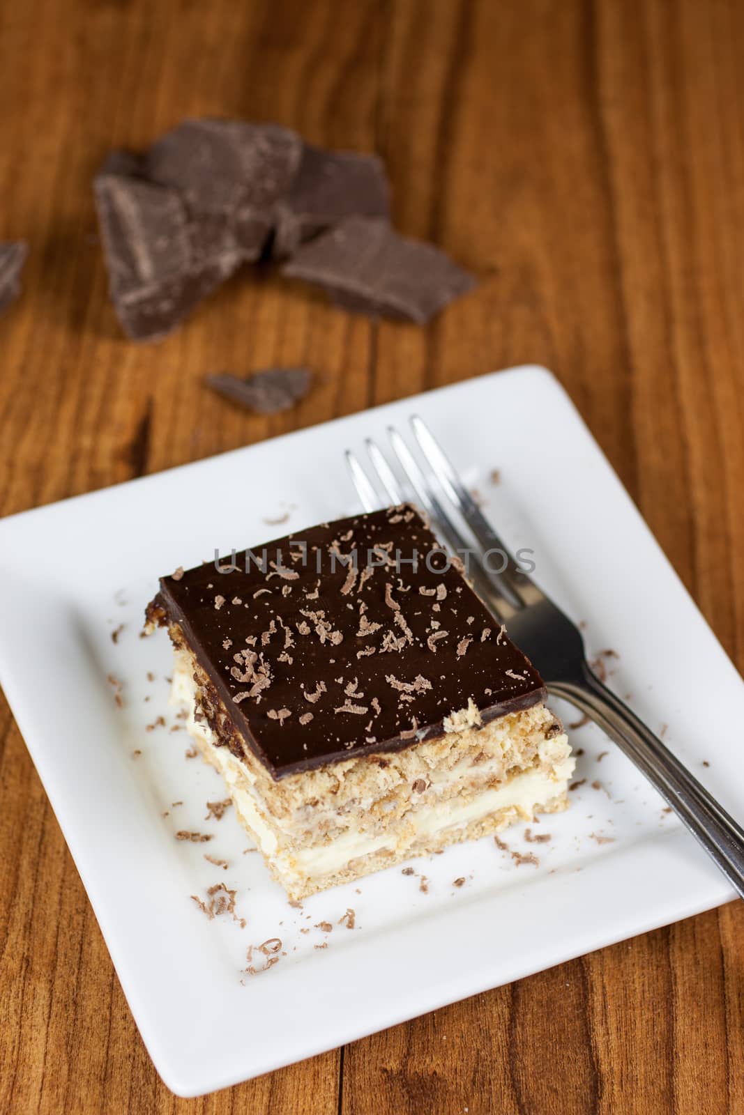 A layered Boston creme pie style dessert made with french vanilla filling and chocolate ganache topping.