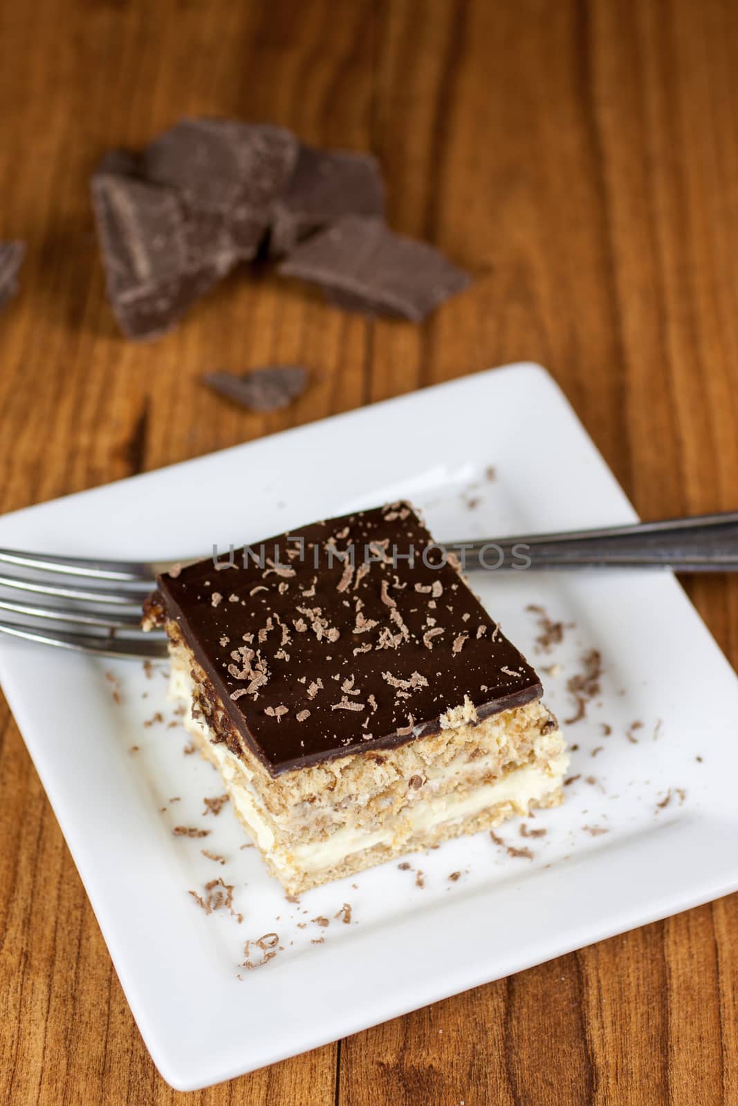 A layered Boston creme pie style dessert made with french vanilla filling and chocolate ganache topping.