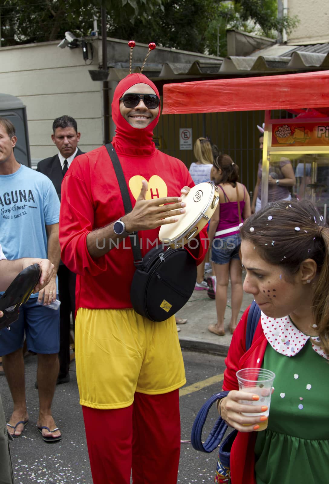 SAO PAULO, BRAZIL - JANUARY 31, 2015: An unidentified man dressed like a Chapulin Colorado participate in the annual Brazilian street carnival dancing and singing samba.