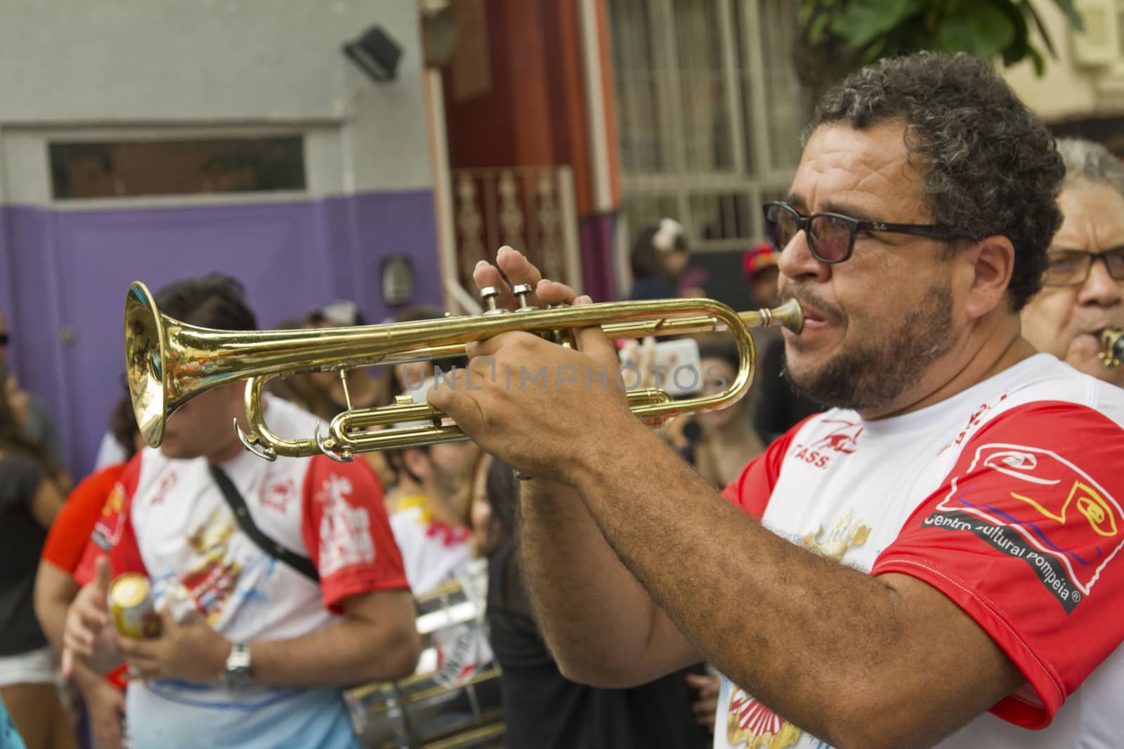 SAO PAULO, BRAZIL - JANUARY 31, 2015: An unidentified man playing trumpet in a traditional samba band participate in the annual Brazilian street carnival.