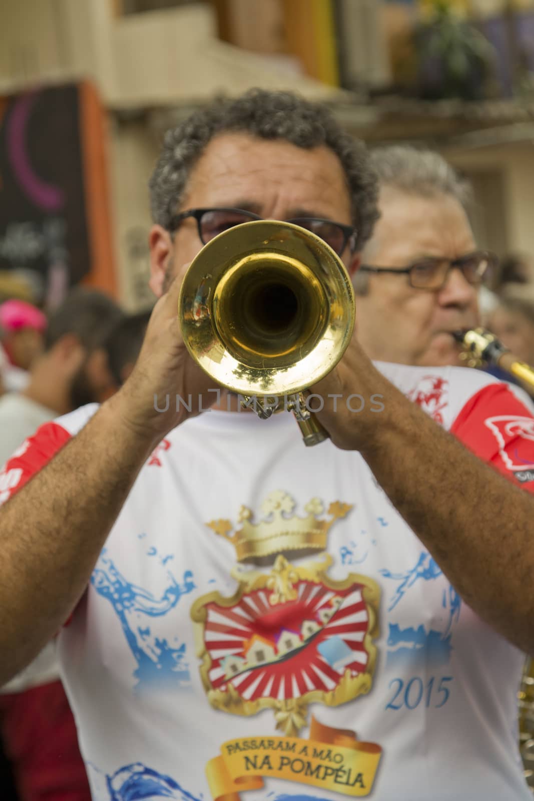 SAO PAULO, BRAZIL - JANUARY 31, 2015: An unidentified man playing trumpet in a traditional samba band participate in the annual Brazilian street carnival.