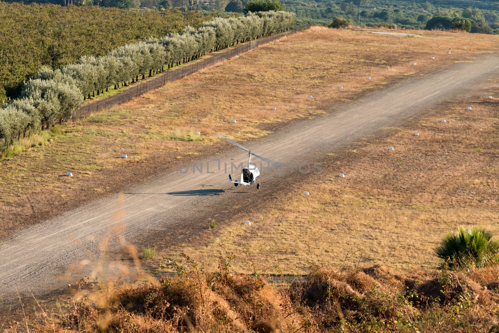 Gyrocopter single pilot prepares to land on the small track