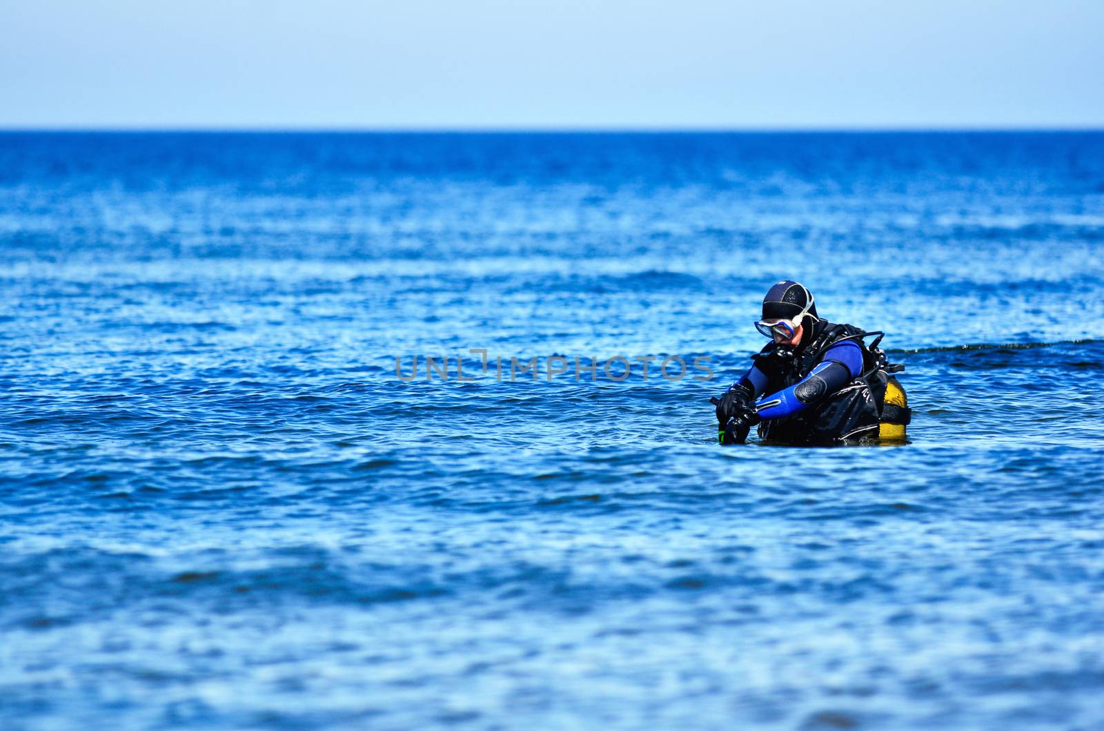 Scuba diver preparing to dive into sea
