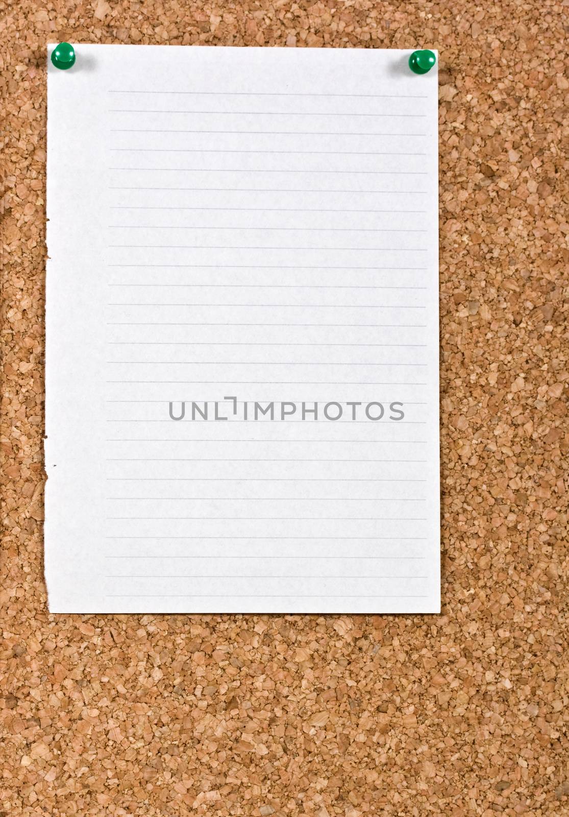 White lined paper pinned to a cork notice board.