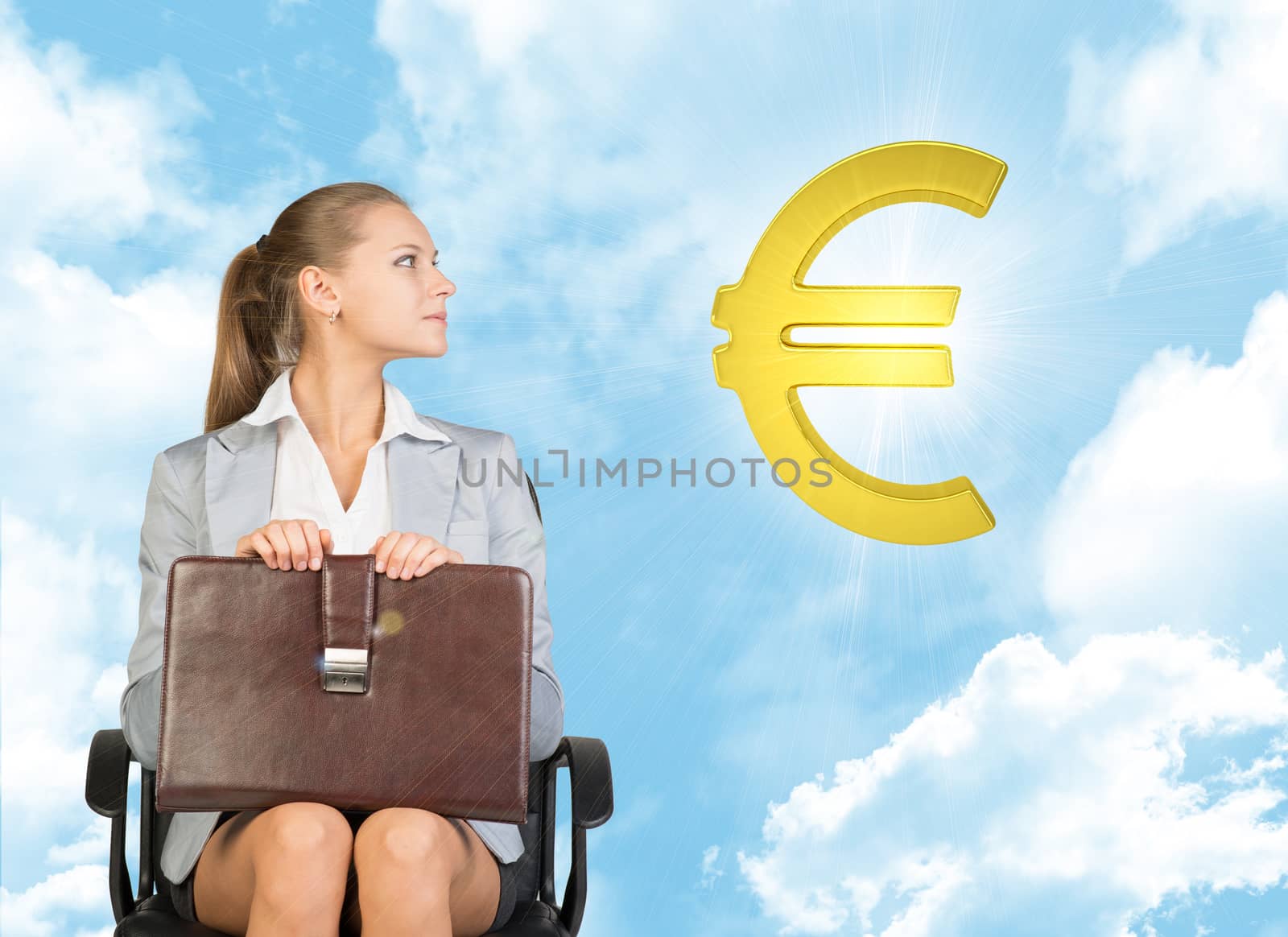 Businesswoman sitting on office chair, holding briefcase on her knees, looking up at golden euro sign in the air, against blue sky with clouds