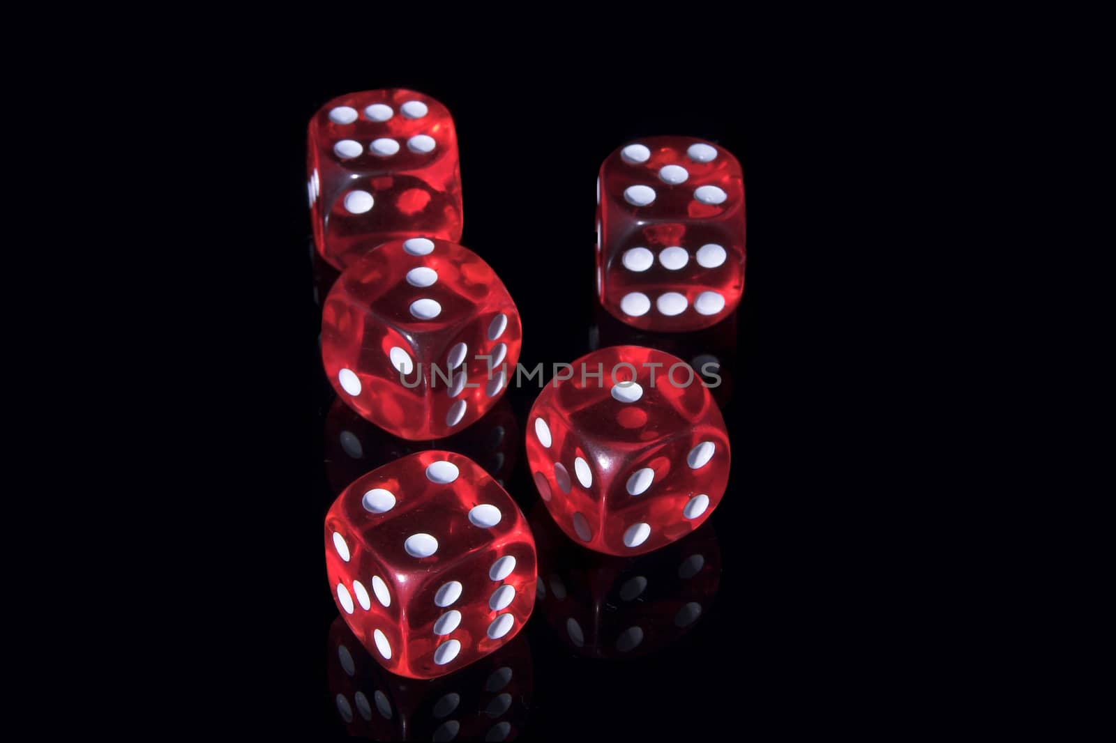 Five red casino dices on the black background