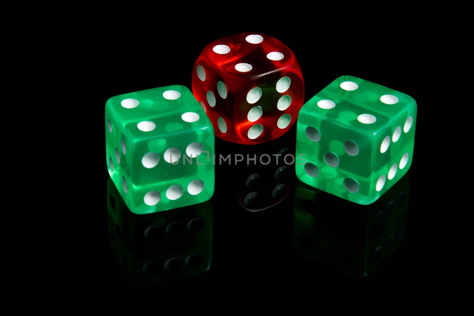 Three casino dice on a black background