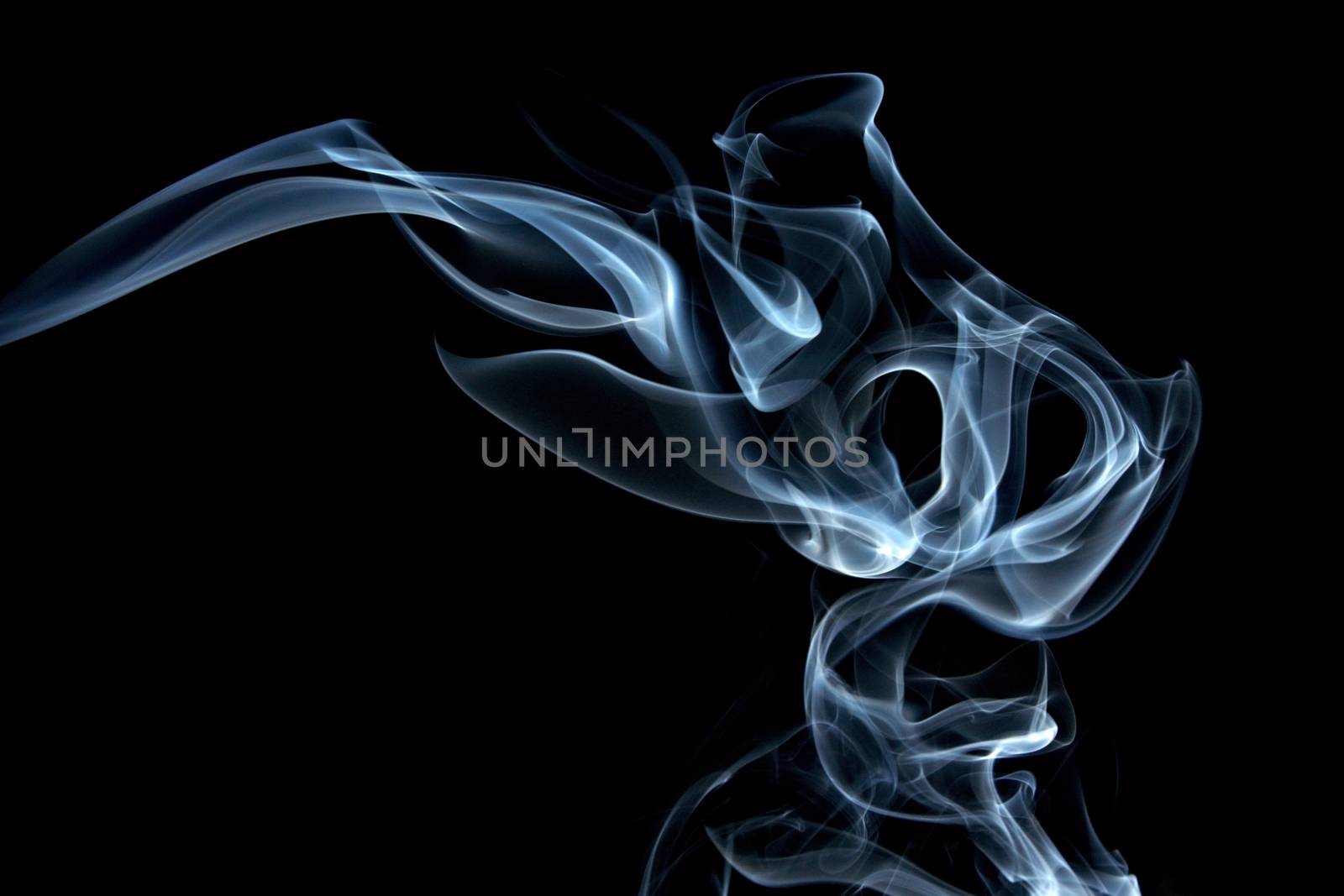 Blue smoke composing to Jinn head on the black background