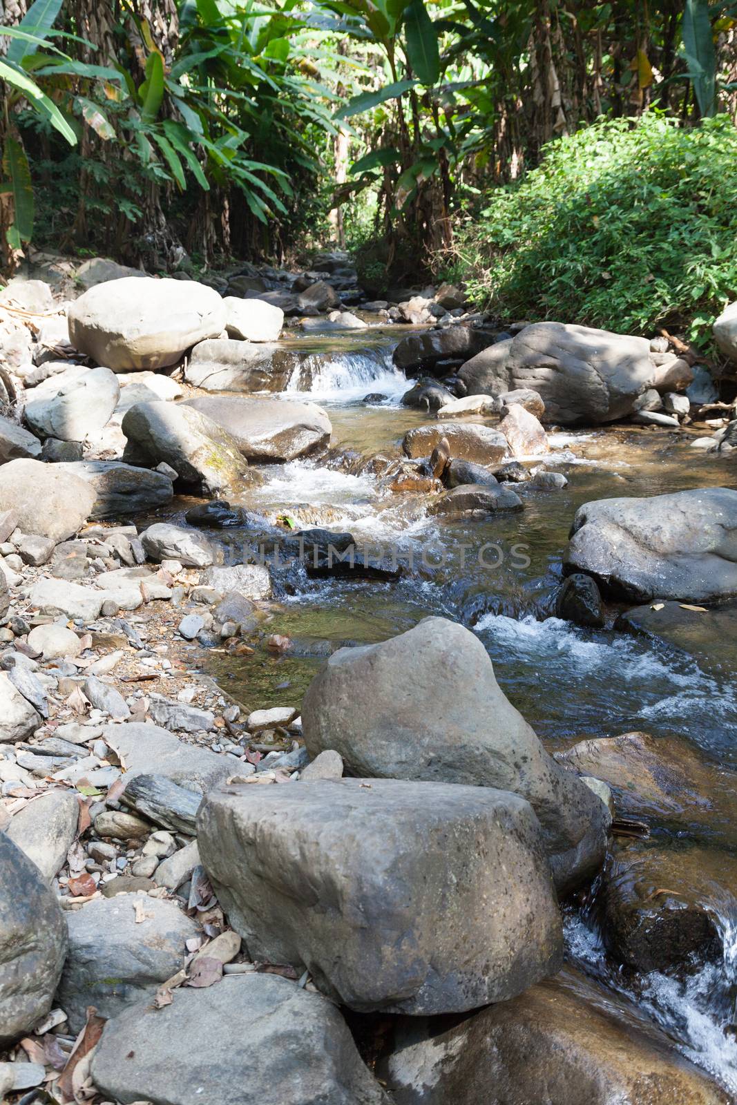 Waterfall that flows down from the mountains. Streams of water flowing down from the mountains. There is always a small stone waterfall.