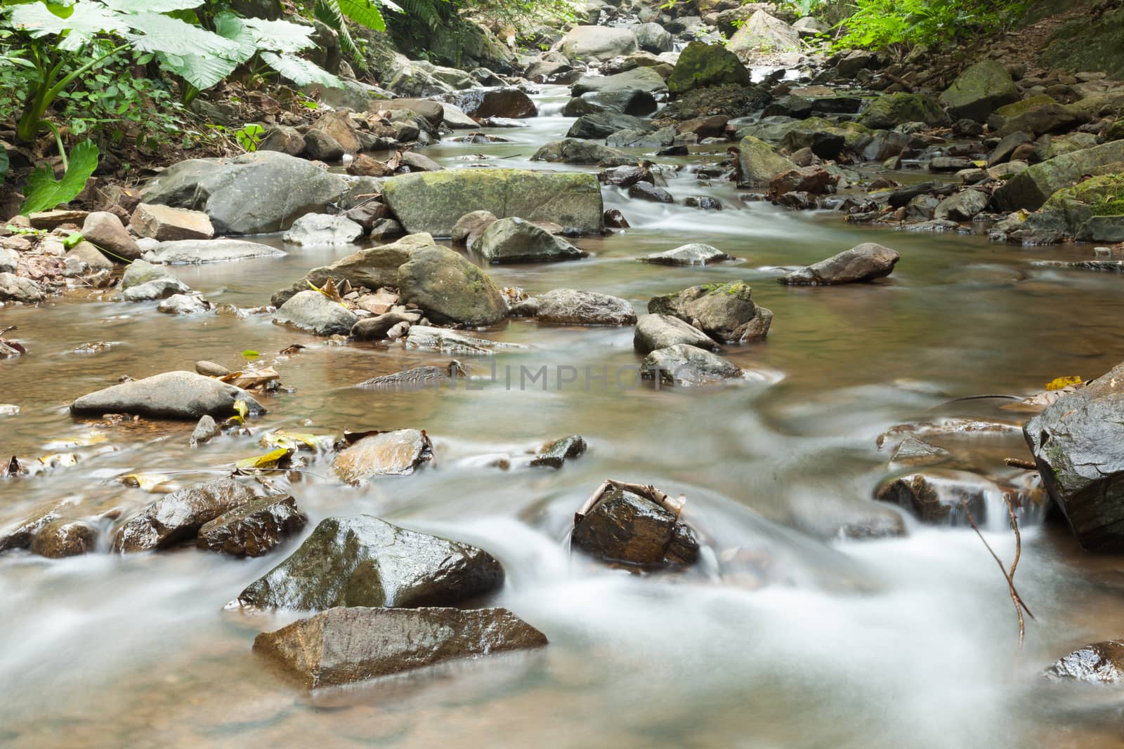 Waterfall that flows down from the mountains. Streams of water flowing down from the mountains. There is always a small stone waterfall.