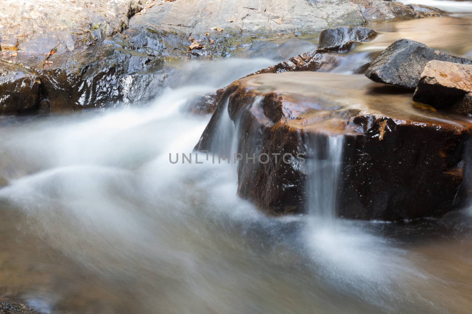 Waterfall that flows down from the mountains. Streams of water flowing down from the mountains. There is always a small stone waterfall.