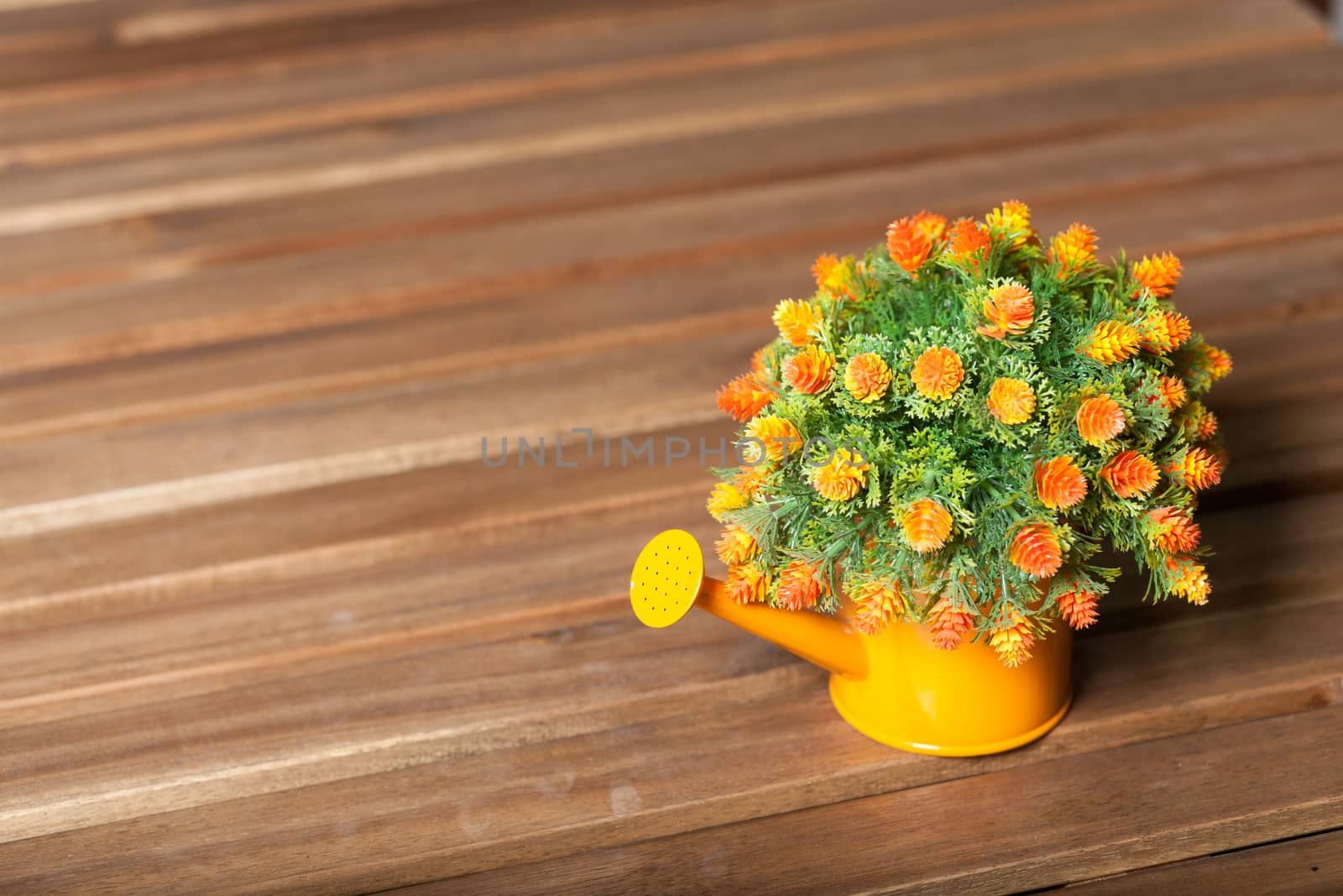 Vase flower pot. Placed on a table made of wood inside the house.