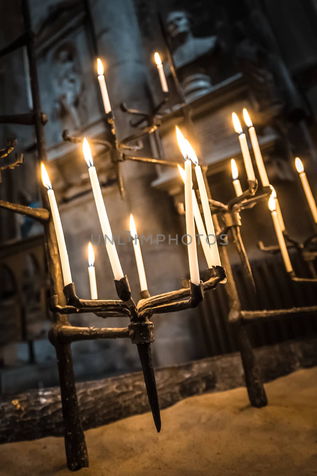 candles burning in a dark gothic building