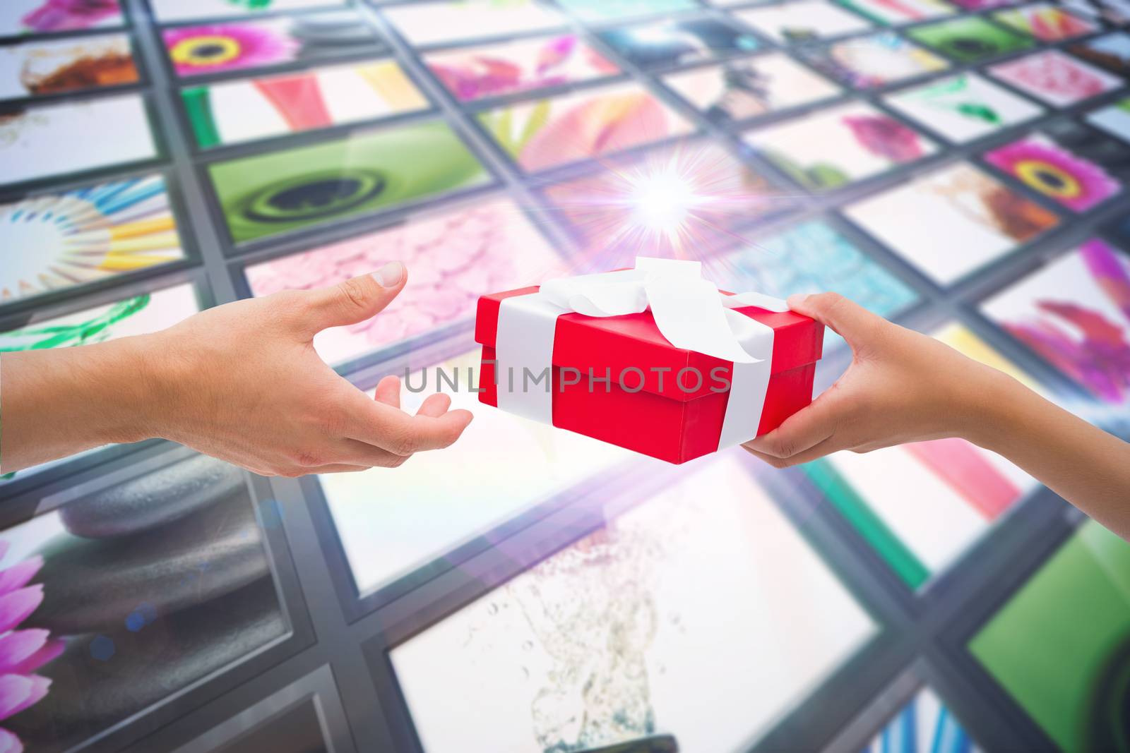 Couple passing a wrapped gift against screen collage showing lifestyle images