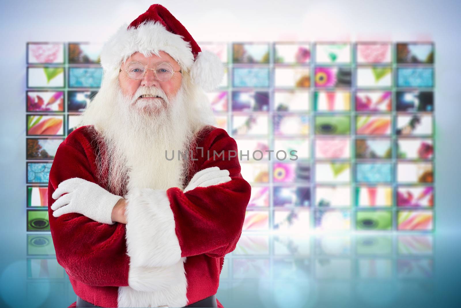 Santa smiles with folded arms against screen collage showing lifestyle images