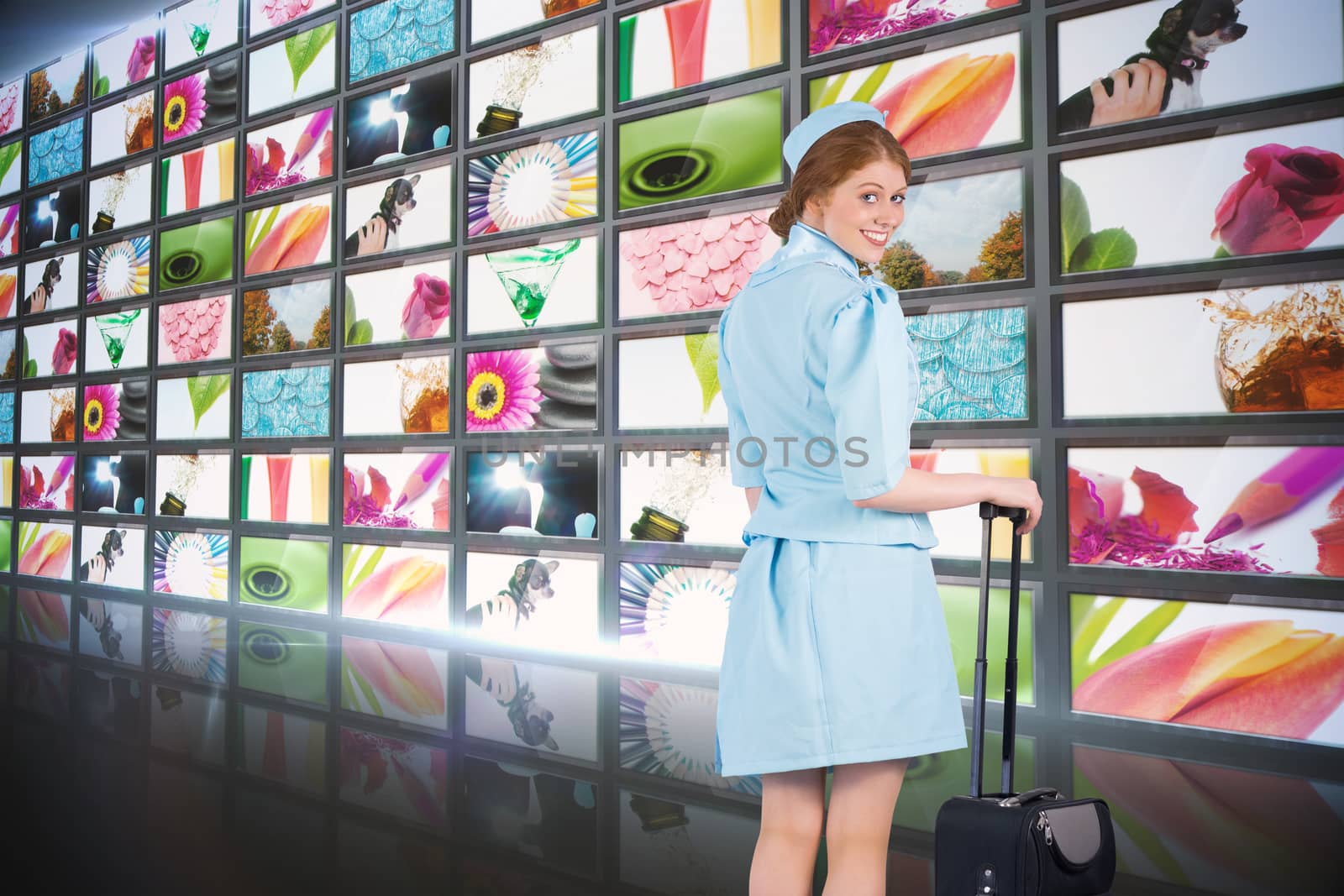 Composite image of pretty air hostess leaning on suitcase by Wavebreakmedia