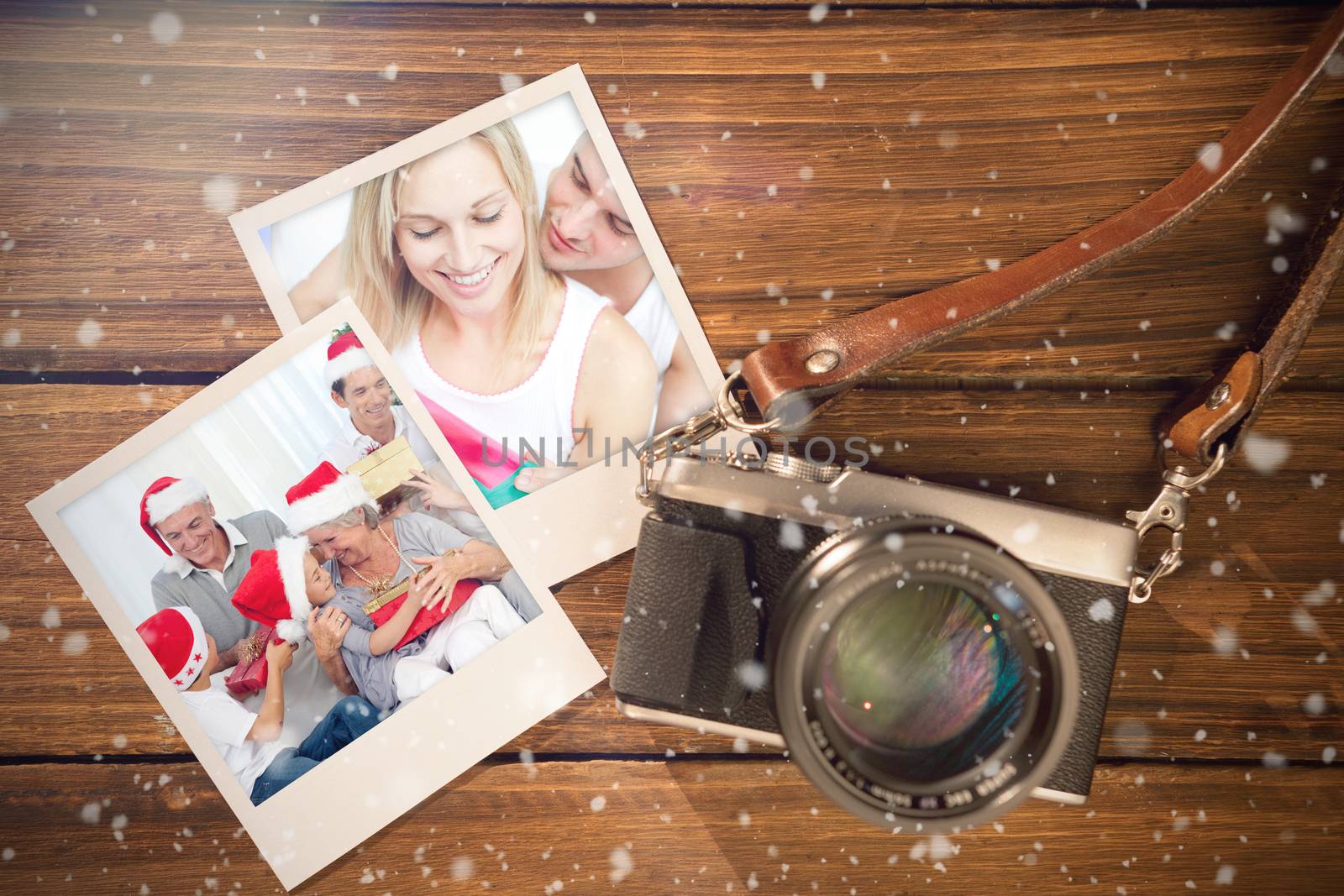 Composite image of christmas memories against instant photos on wooden floor