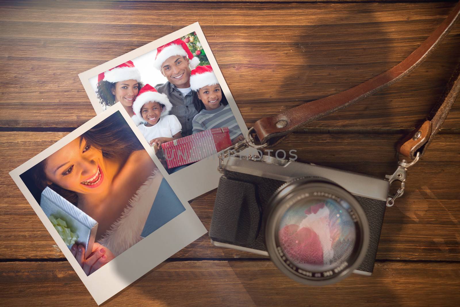 Composite image of christmas memories against instant photos on wooden floor